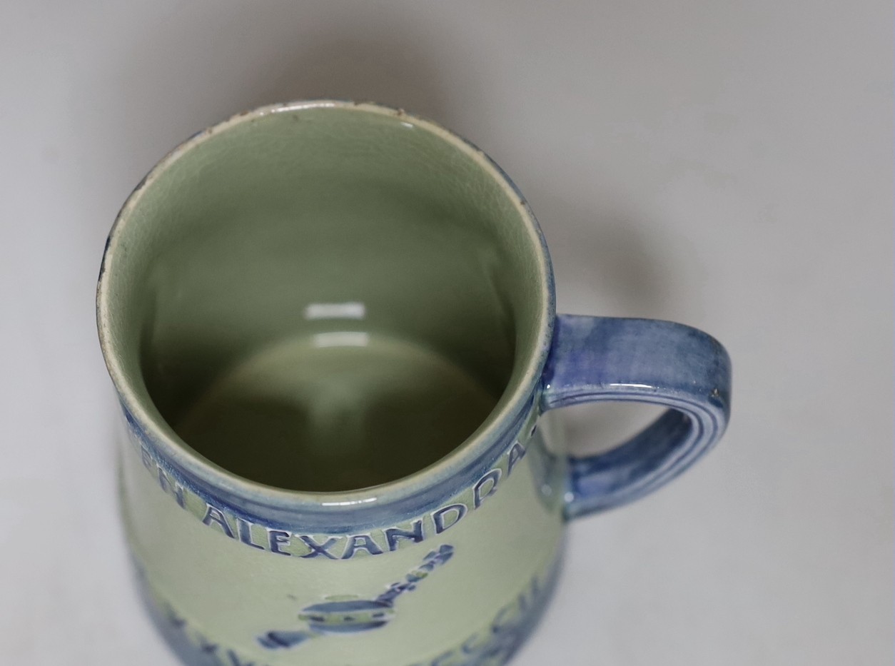 A Moorcroft Coronation of Edward VII and Queen Alexandra 1902. Tapering mug decorated in blue with underside inscription, From Mr and Mrs Lazenby Liberty, Lee Manor, Bucks and monograms. no. 112 of 250, 9.5cm tall